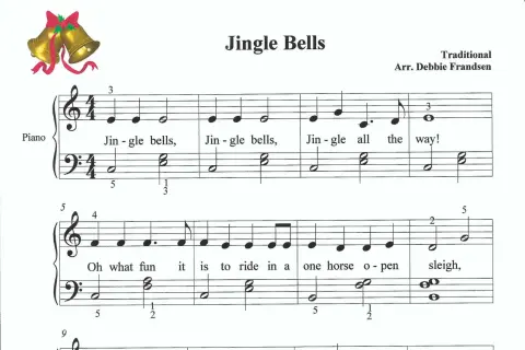 Nuty do piosenki "Jingle Bells" na keyboard. Złote dzwoneczki z czerwoną wstążką.