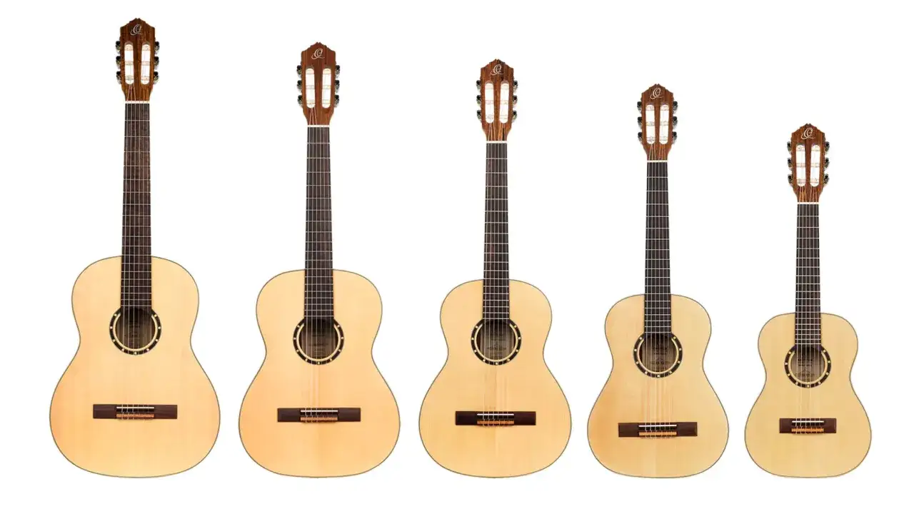 Rząd pięciu gitar klasycznych dla początkujących, od największej do najmniejszej. Idealne do nauki gry.